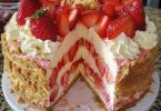 Strawberry birthday cake with whipped cream and fresh strawberries