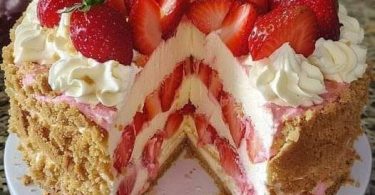 Strawberry birthday cake with whipped cream and fresh strawberries