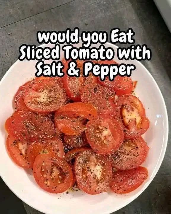 Sliced tomato with salt and freshly cracked black pepper